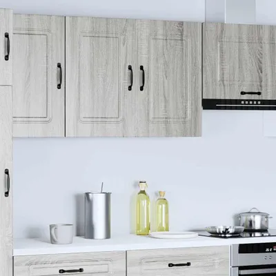 A modern kitchen scene with gray wood-effect cabinets and appliances.