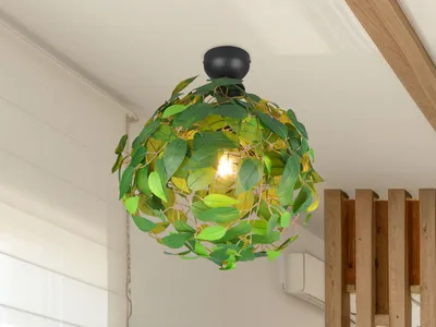 A decorative ceiling lamp with green leaves is shown hanging from a white ceiling, with wooden beams and a wall in the background.