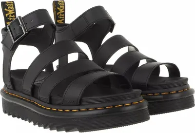 A pair of black Dr. Martens platform sandals.