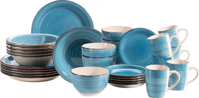 A collection of blue and white ceramic dishes and mugs are arranged on a white background.