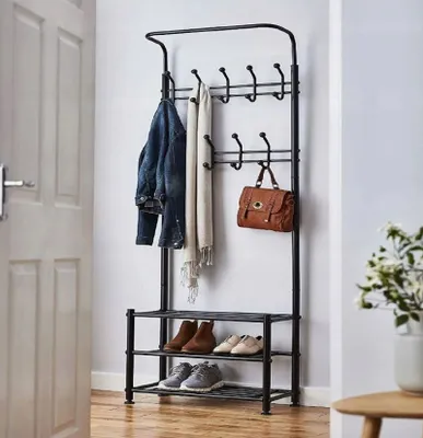 A coat rack with shoes and accessories in an entryway.