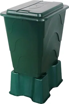 A green compost bin with a lid, placed on a green base.