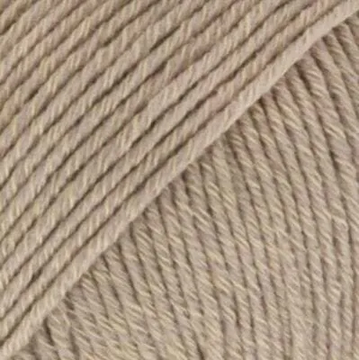A close-up, textured view of beige yarn.