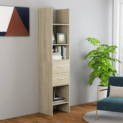 A tall, narrow bookshelf with two drawers and several shelves, placed against a light gray wall next to a potted plant and a chair.