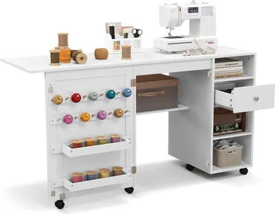 A white sewing cabinet with a sewing machine on top and various sewing supplies stored inside and on the cabinet.