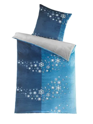 A folded duvet cover and a pillowcase with a snowflake pattern.