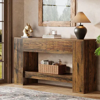 A wooden console table with decorative items and a lamp, placed in a room near a window.