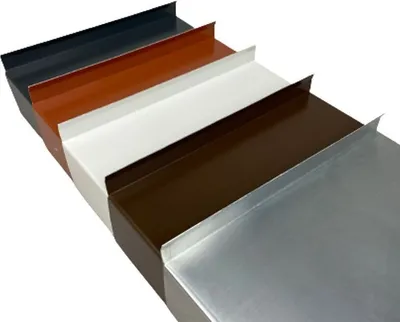 Several pieces of metal flashing in different colors are arranged diagonally on a white background.