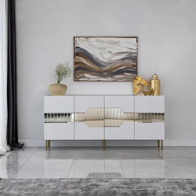 A modern white sideboard with gold accents is displayed in a clean, minimalist room.