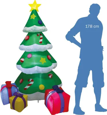 An inflatable Christmas tree with gifts and a silhouette of a person for scale.