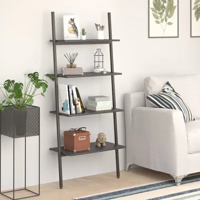 A ladder shelf unit with various decorative items and books, placed next to a sofa in a living room.