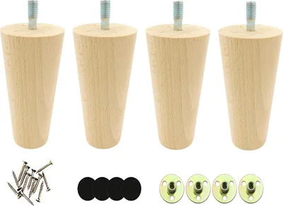 Four wooden furniture legs with metal screws and mounting plates, along with four felt pads, are arranged on a white background.