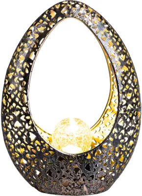 An oval-shaped decorative lamp with a cut-out pattern and a glowing orb inside.