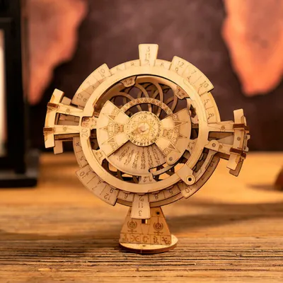 A wooden 3D puzzle of a perpetual calendar sits on a wooden table.