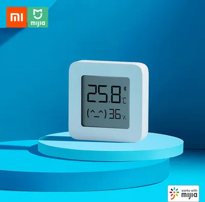 A white Xiaomi BT Thermometer 2 is displayed on blue circular platforms against a blue background.