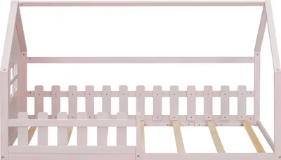 A pink wooden house-shaped bed frame with a picket fence detail, shown from the side.