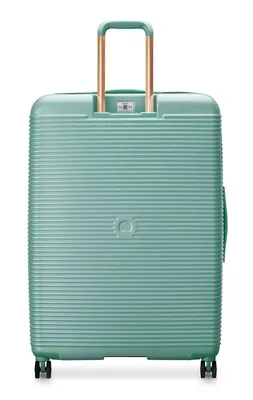 The back of a mint green suitcase with gold telescopic handle and wheels.