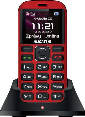 A red Aligator A720 4G senior mobile phone is displayed in a black charging dock against a light gray background.