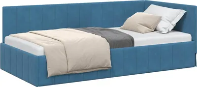 A blue corner bed frame with a headboard, made of velvet, with bedding and pillows on it.