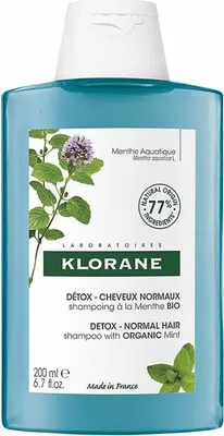 A bottle of Klorane shampoo with mint illustration.