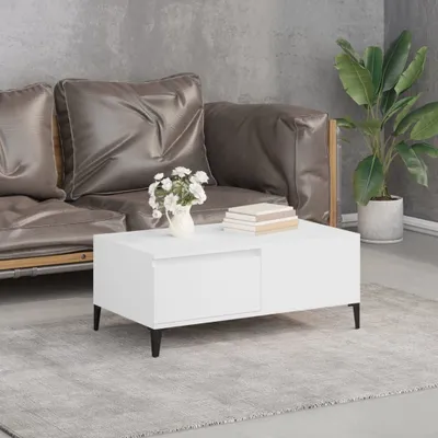 A modern living room scene featuring a white coffee table, a grey couch, and a potted plant.