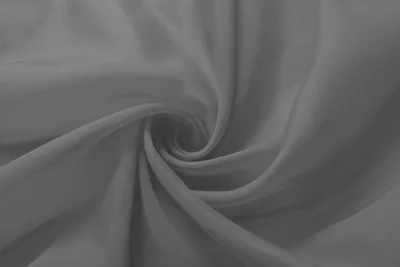 A close-up, swirled view of dark gray sheer fabric.