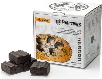 A product box for charcoal briquettes with some briquettes in the foreground.