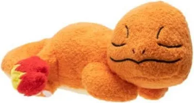 A plush toy of the Pokémon Charmander is lying on its side.