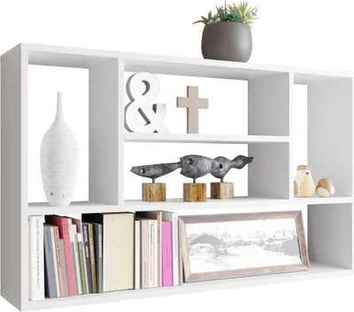A white wall shelf with various decorative items and books.