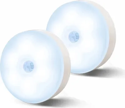 Two round, white LED night lights with a light blue glow and a central sensor.
