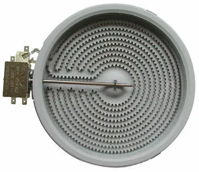 A close-up, high-angle studio shot of a round electric stove burner element with a visible heating coil and electrical connection.