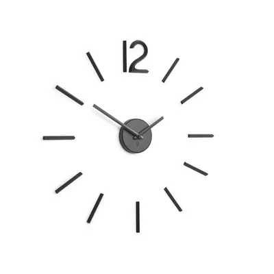 A modern wall clock with a minimalist design, featuring a central clock mechanism and individual hour markers that can be applied to the wall.