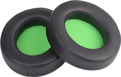 Two black ear pads with green inner padding are shown against a white background.