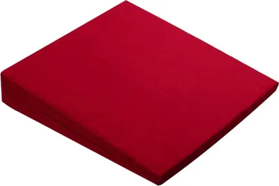 A red wedge pillow is shown from a diagonal angle against a white background.
