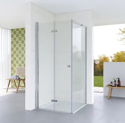 A modern bathroom with a glass shower enclosure, marble-tiled walls, and a patterned wallpaper.