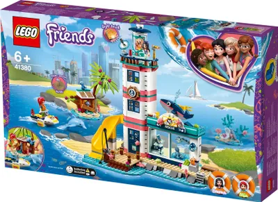 The image shows the packaging of a LEGO Friends lighthouse playset, depicting the assembled toy in a vibrant seaside scene with various characters and accessories.