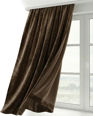 A brown velvet curtain is draped over a window.