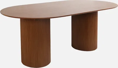 An oval dining table with two cylindrical, fluted bases.