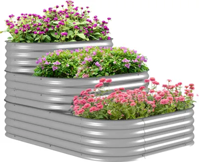 A tiered metal raised garden bed filled with blooming flowers.