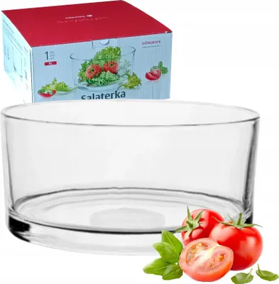 A glass salad bowl with tomatoes and basil in front of it, and a product box in the background.