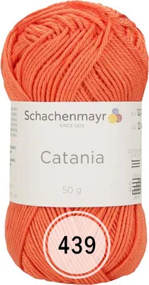 A ball of orange yarn with a label.