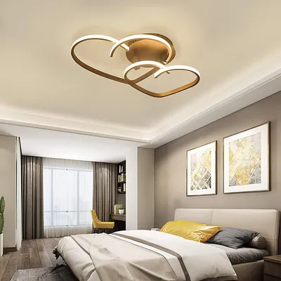 A bedroom with a bed, curtains, and artwork on the wall, featuring a heart-shaped ceiling lamp.