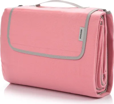 A folded pink picnic blanket with gray trim and a handle.