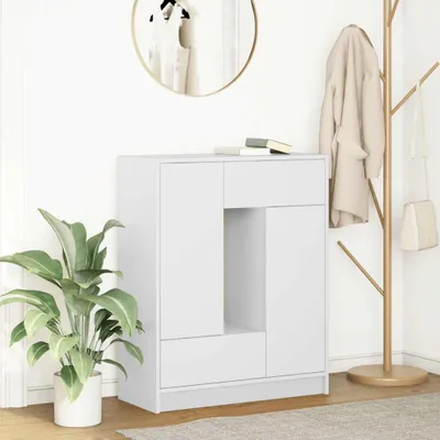 A white sideboard with drawers and doors is shown in a room with a plant and a coat rack.
