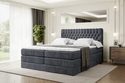 A bedroom scene with a large bed as the focal point.