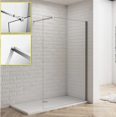 A frameless glass shower wall with a silver support bar, installed in a bathroom with a brick-patterned wall and a light-colored shower tray.