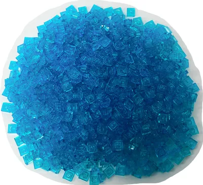 A pile of small, transparent, light blue square plastic pieces.