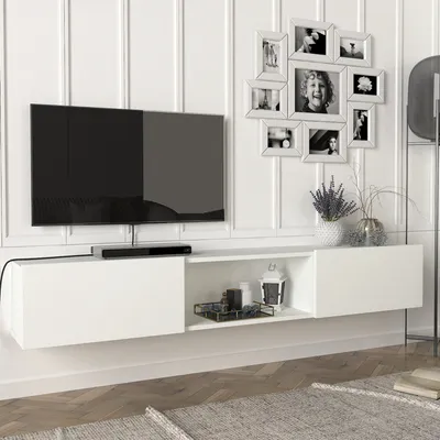 A modern living room setup featuring a wall-mounted TV and entertainment unit.