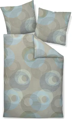 A bedding set with two pillowcases and a duvet cover, all featuring a circular pattern.