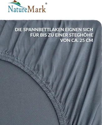A close-up of a grey fitted sheet, showing the elasticated edge and fabric texture.